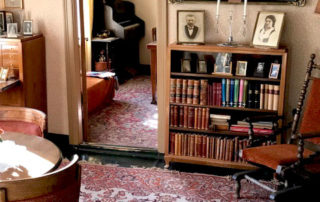 Photographs, books, a few pictures of nature, Persian rugs, an inviting chair for reading occupy the shop's apartment.